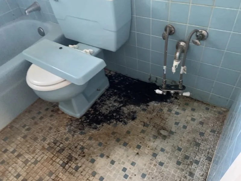 Before: dated bathroom with a damaged shower floor in a South Florida fourplex we bought
