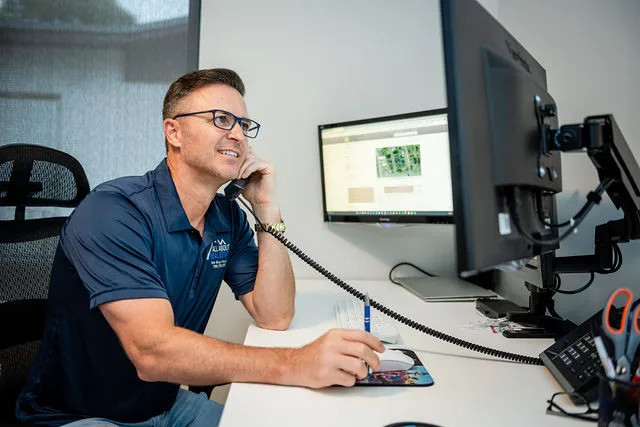 Petru Pusta on the phone with a homeowner at the All About Real Estate office